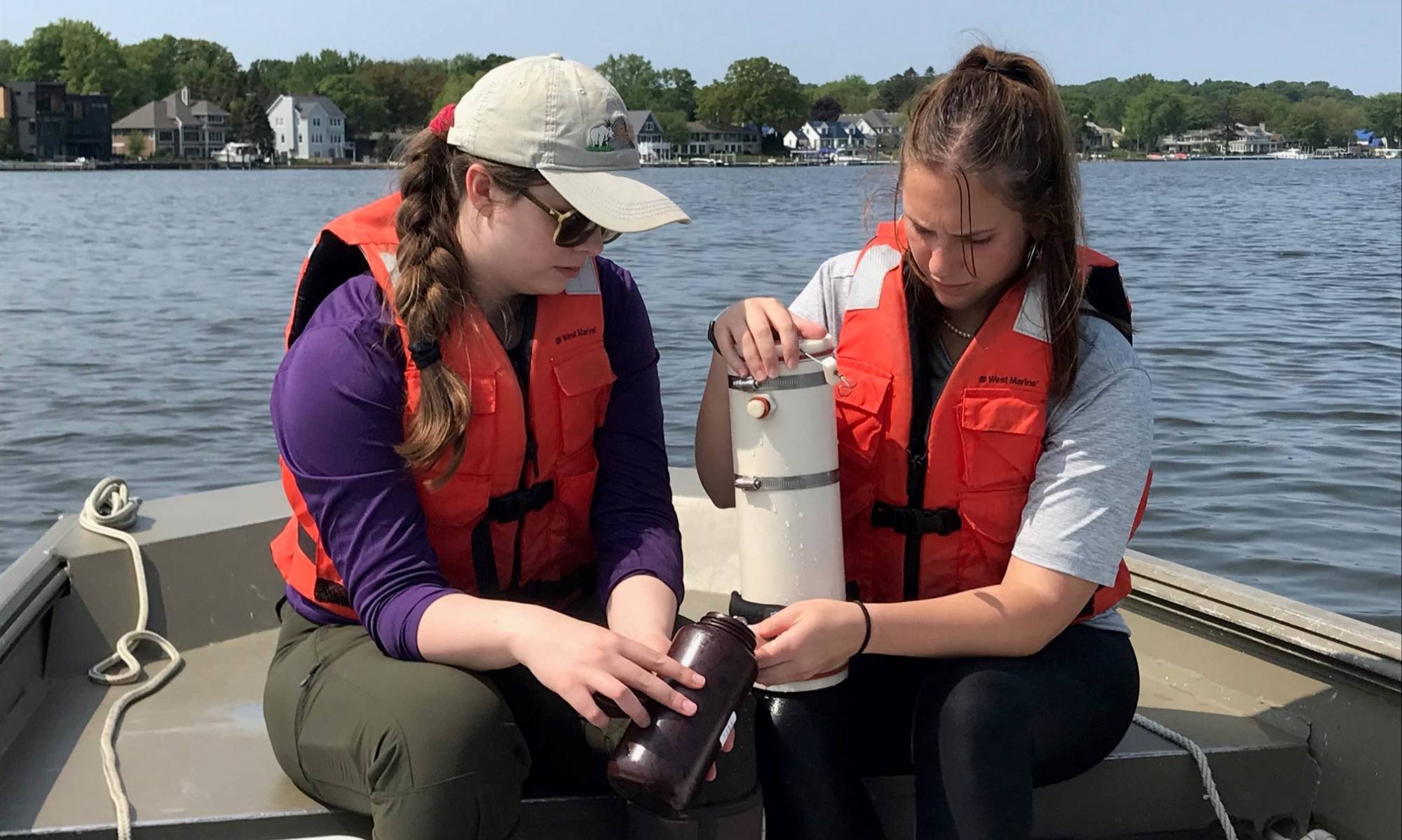 Two undergraduate students sample water quality for the Bear Lake watershed assessment project.